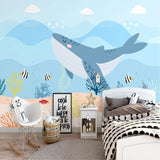 Ocean Whale Wallpaper in cozy nursery with white furniture showing scale and soft blue tones