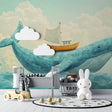 Ocean whale wallpaper mural in a bright nursery with white furniture and soft textiles