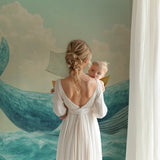 Ocean mural wallpaper bringing coastal charm to a baby's room with natural light