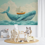 Nautical wall mural installation showcasing the full whale and sailboat scene in a child's bedroom