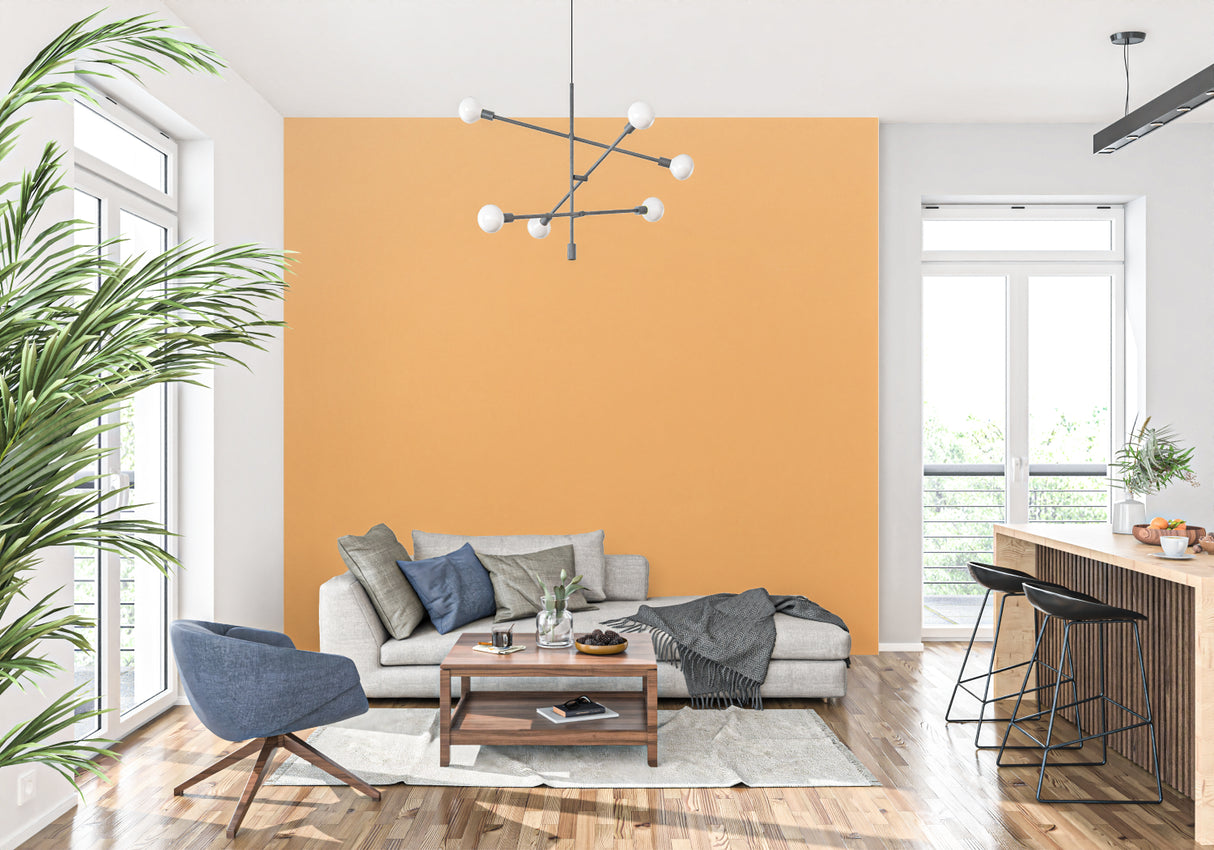 Modern office space featuring orange accent wall mural with desk setup