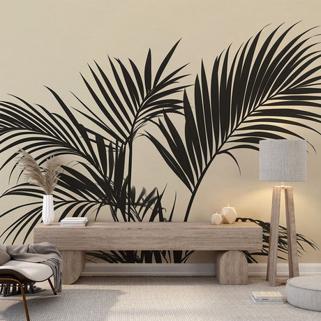 Palm leaf wallpaper creating a modern tropical atmosphere in a minimalist living room with beige sofa and black accents