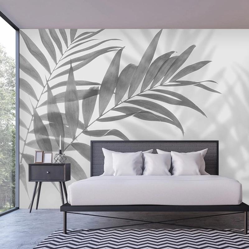 Modern Palm Leaf Mural Wallpaper creating a dramatic focal point in a minimalist living room setting