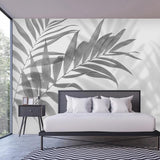 Modern Palm Leaf Mural Wallpaper creating a dramatic focal point in a minimalist living room setting