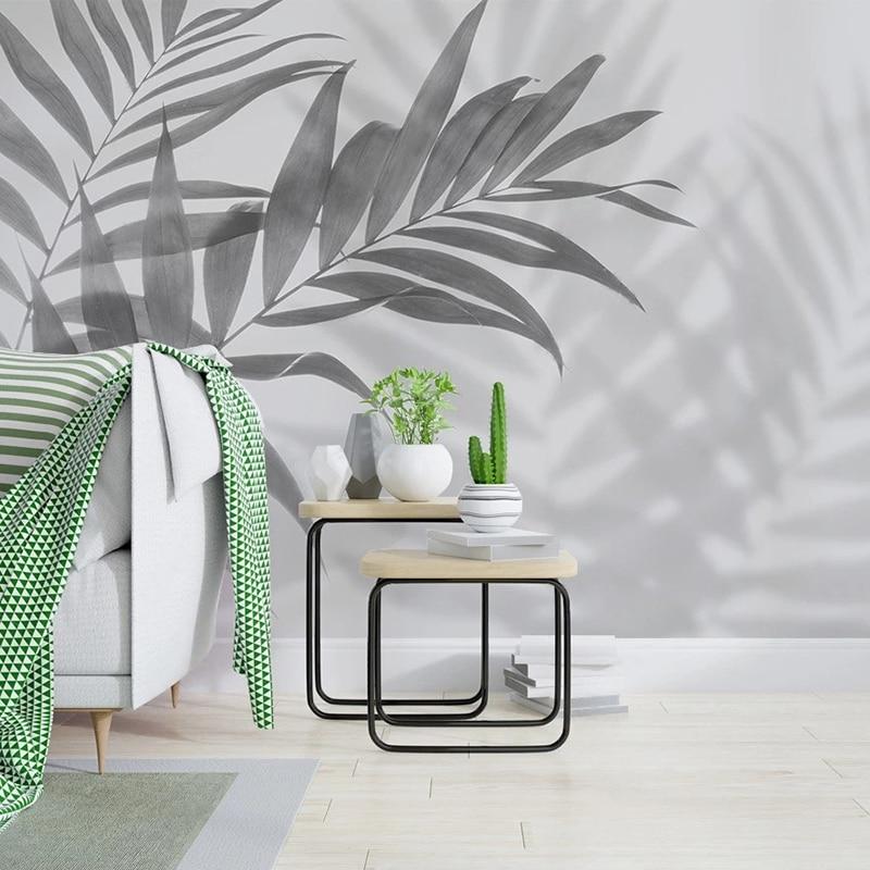 Botanical wall mural with palm shadows adding depth to a contemporary bedroom space
