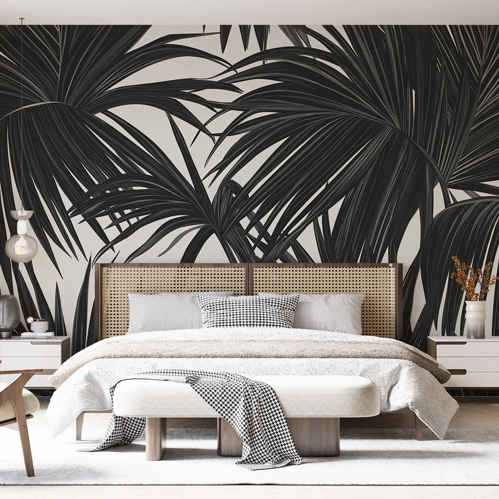 Black and white palm leaves wallpaper creating dramatic contrast in a modern living room with minimal furniture