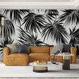 Modern black and white palm leaves wallpaper creating dramatic contrast in a minimalist living room setting