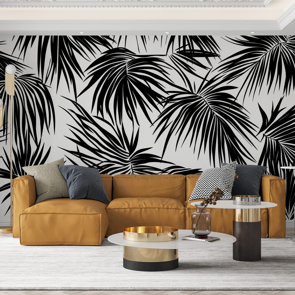 Modern black and white palm leaves wallpaper creating dramatic contrast in a minimalist living room setting