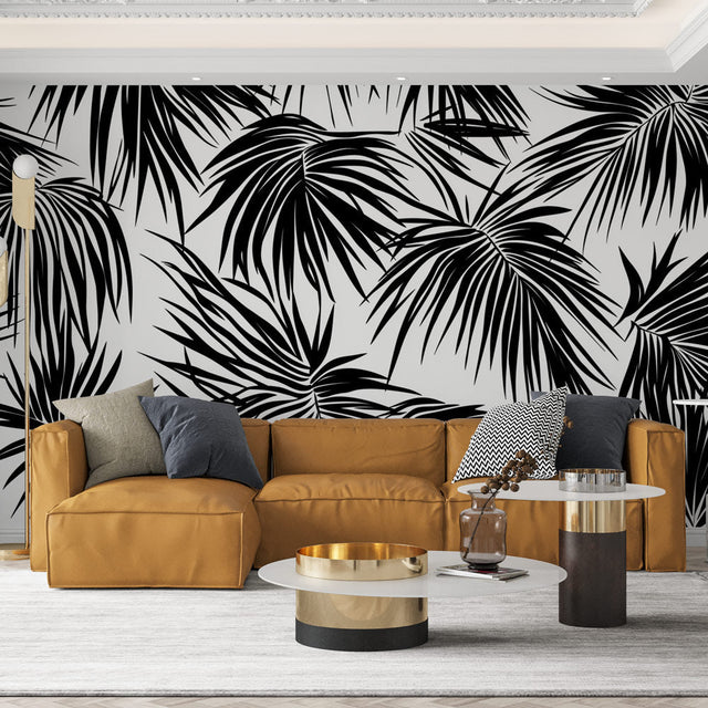 Modern black and white palm leaves wallpaper creating dramatic contrast in a minimalist living room setting
