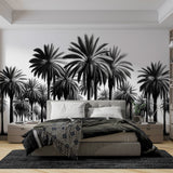 Black and white palm tree mural wallpaper creating dramatic impact in modern living room with minimalist furniture