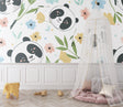 Panda nursery wallpaper in soft pastels bringing charm to a modern nursery with white furniture