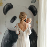 Watercolor panda wall mural in a playroom with natural wood elements
