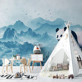 Mountain landscape wallpaper with panda bringing character to a child's reading nook
