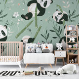 Kids bedroom with panda mural wallpaper showing playful scene above white furniture