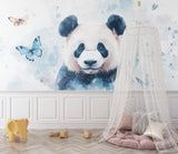 Watercolor panda wall mural brightening a child's reading nook with soft lighting