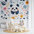 Panda wallpaper mural in bright nursery with white furniture showing watercolor pandas and orange flowers
