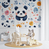 Panda wallpaper mural in bright nursery with white furniture showing watercolor pandas and orange flowers