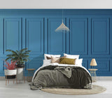 Blue wall paneling wallpaper creating elegant depth in a modern living room with grey sofa and natural light