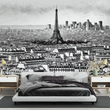 Paris cityscape mural wallpaper creating an elegant statement wall in a modern living room with minimal furniture