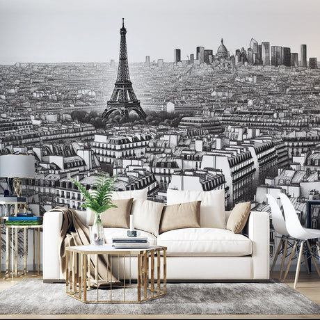 Black and white Paris cityscape wallpaper creating depth in modern living room with gray sofa and minimal decor