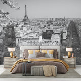 Black and white Paris mural wallpaper in an elegant dining room setting with crystal chandelier