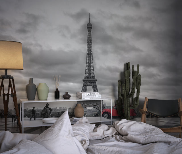 Paris cityscape wallpaper creating drama in a modern living room with black and white furniture
