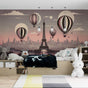 Paris Hot Air Balloon wallpaper creates a magical atmosphere in a girl's bedroom, with soft pink sunset tones