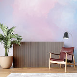 Pink and blue gradient mural in a cozy bedroom setting with natural light