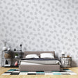 Modern grey teardrop pattern wallpaper in a bright Scandinavian living room, creating a peaceful atmosphere