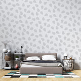 Modern grey teardrop pattern wallpaper in a bright Scandinavian living room, creating a peaceful atmosphere