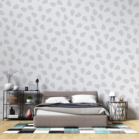 Modern grey teardrop pattern wallpaper in a bright Scandinavian living room, creating a peaceful atmosphere