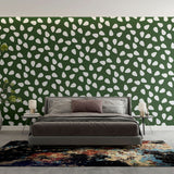 Modern green pattern wallpaper with white drops creating a fresh look in a bright living room setting
