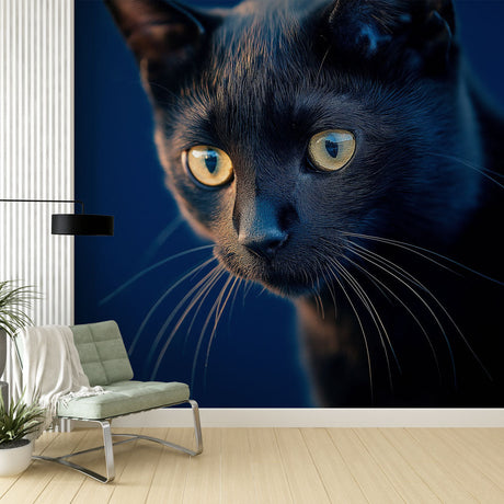 Black cat wall mural with golden eyes creating dramatic atmosphere in modern living room with grey sofa and minimal decor