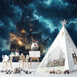 Pirate ship wallpaper creating magic in a cozy kids bedroom with soft night sky glow and starlight effects