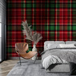 Red and green tartan wallpaper in a cozy living room setting with leather armchair