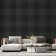 Green Buffalo Check Wallpaper creating a cozy atmosphere in a modern living room with leather furniture and natural light