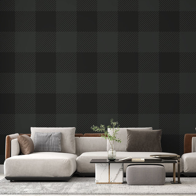 Green Buffalo Check Wallpaper creating a cozy atmosphere in a modern living room with leather furniture and natural light
