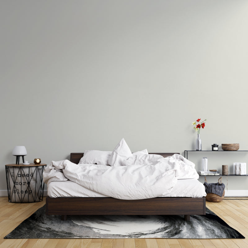 Plain beige wall mural creating serene atmosphere in minimal bedroom setting