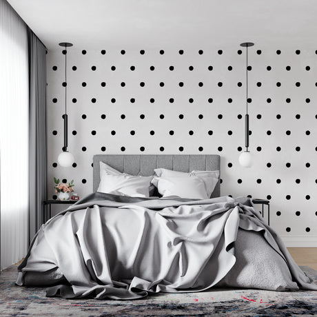 Modern black and white polka dot wallpaper in a minimalist living room setting