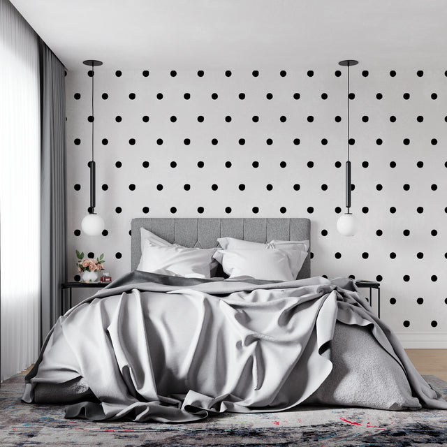 Modern black and white polka dot wallpaper in a minimalist living room setting