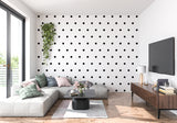 Black and white polka dot mural adding character to a modern dining room