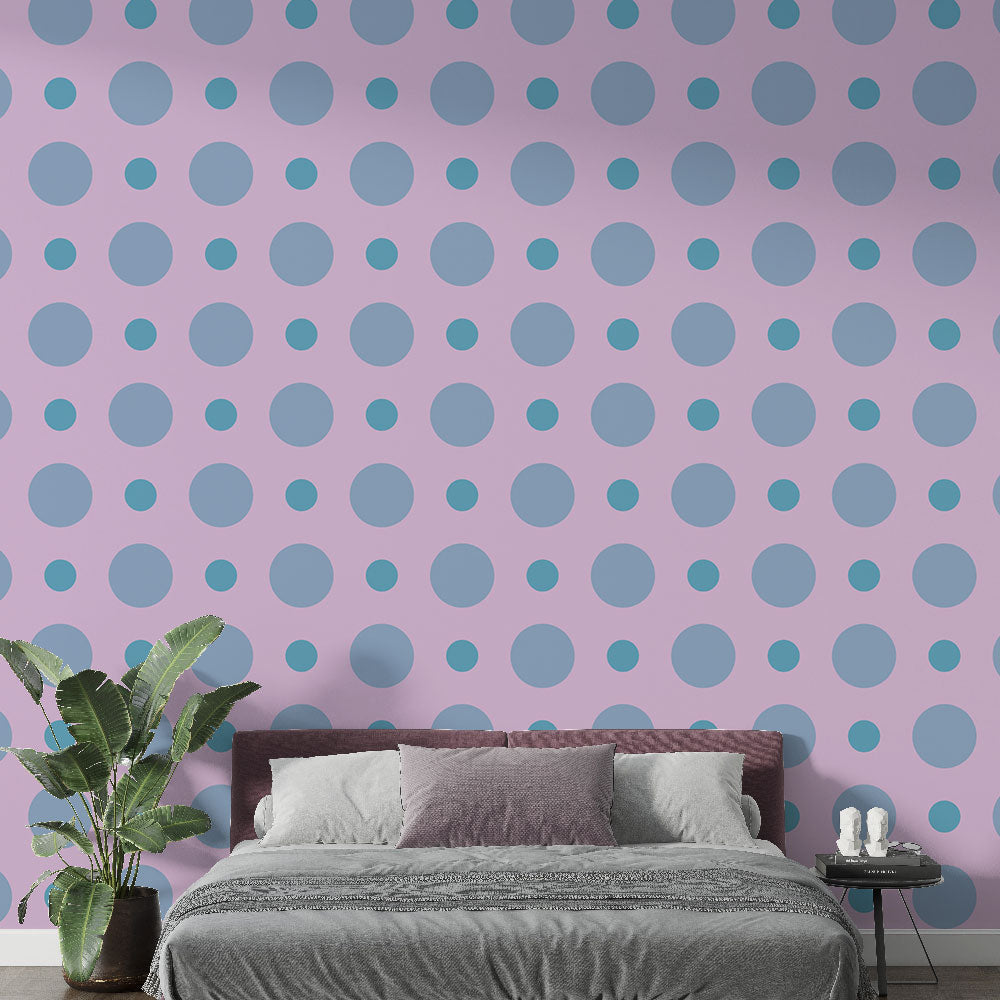 Pink and blue polka dot wallpaper creating a cheerful atmosphere in a modern nursery with white furniture