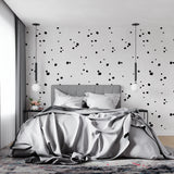 Black and white dot pattern wallpaper in a minimalist home office space