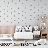 Silver polka dot wallpaper creating a magical atmosphere in a modern nursery with soft lighting