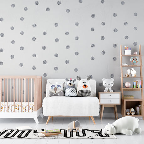 Silver polka dot wallpaper creating a magical atmosphere in a modern nursery with soft lighting