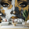 Black and gold abstract portrait wallpaper creating a bold statement in a modern living room with minimalist furniture