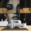 Black and gold portrait mural wallpaper creating dramatic impact in a modern living room with high ceilings
