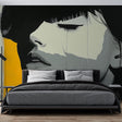 Modern portrait wall mural creating dramatic impact in a minimalist living room with high ceilings and natural light