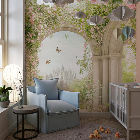 Princess castle wallpaper in a pink nursery with white furniture and soft lighting