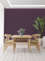 Home office featuring deep purple wall mural with minimalist desk setup